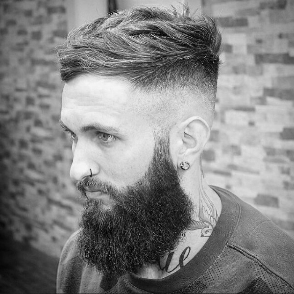 High Fade Hairstyle for Tattooed Men With Wavy Hair