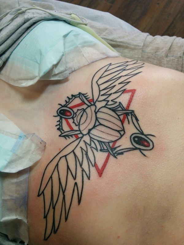 Sternum Tattoo Idea of an Egyptian Beetle Against a Red Triangle