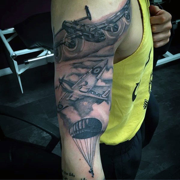 Upper Arm Military Inspired Tattoo of a Fighter Jet and Parachutes Descending