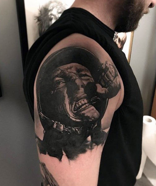 Upper Arm Tattoo of an Emotional Soldier Holding Onto a Grenade