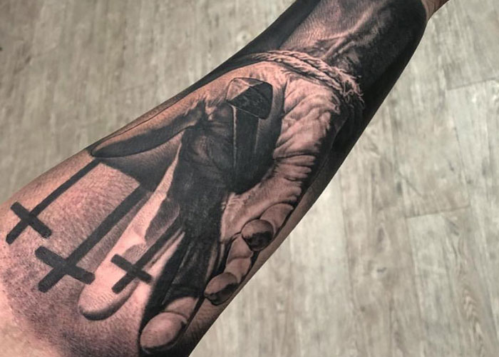 Forearm Tattoo in Remembrance of Jesus Being Nailed to the Cross
