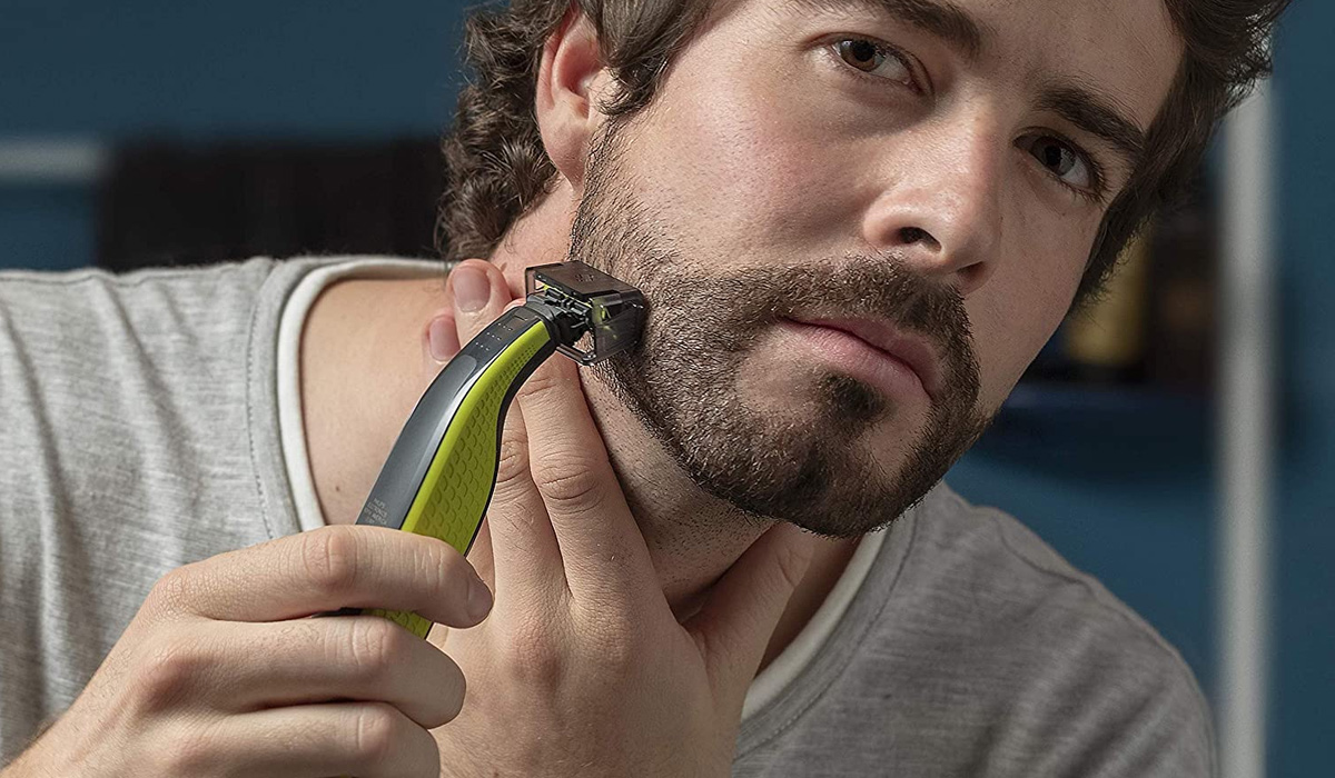 man using a beard trimmer