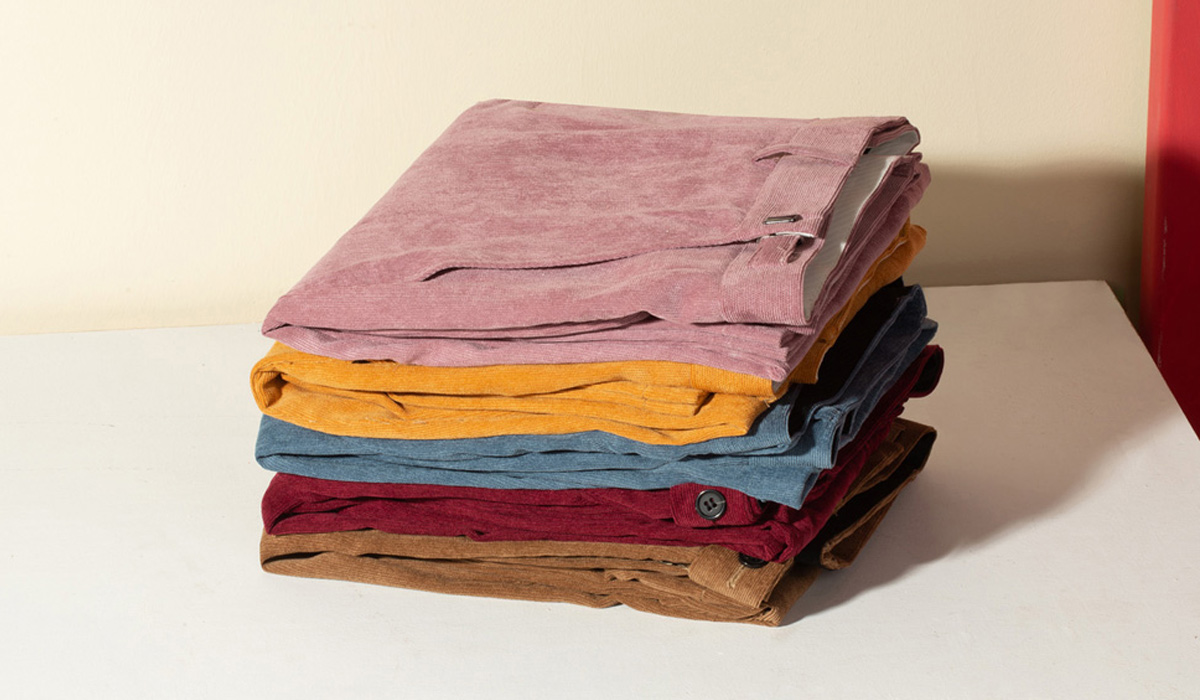 folded corduroy pants on a table