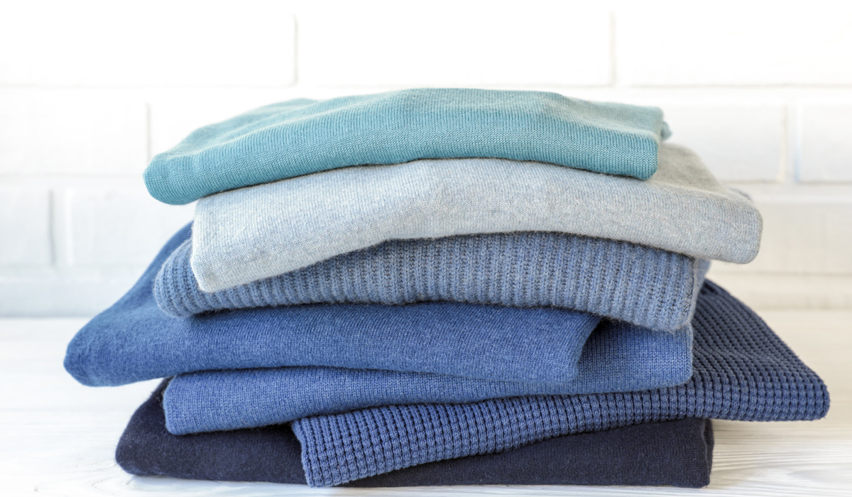 stack of folded affordable cashmere sweaters for men