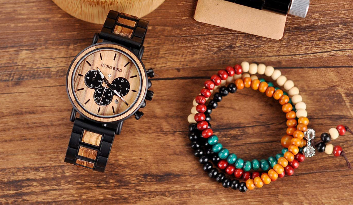 wooden watch besides a colored bracelet